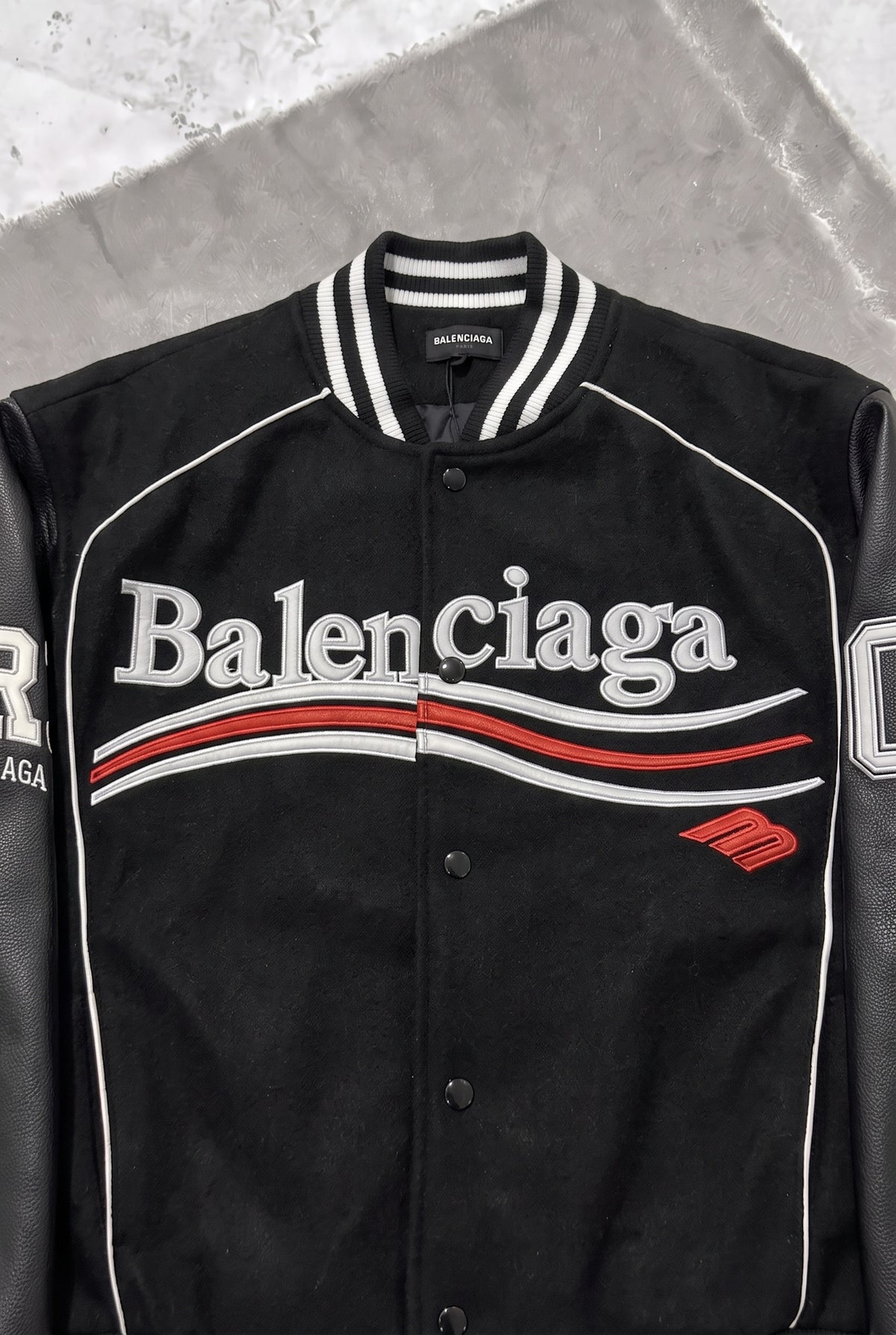 BALENCIAGA Political Campaign Varsity Jacket in Wool and Leather – Black – chest logo close-up