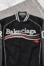 BALENCIAGA Political Campaign Varsity Jacket in Wool and Leather – Black – chest logo close-up