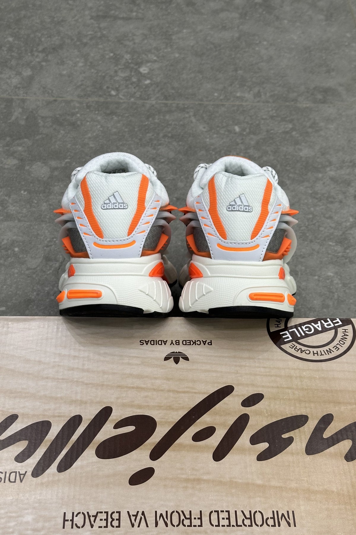 Pharrell Williams x Adidas Adistar Jellyfish – Focus Olive/Core Black/Orange – heels on the box